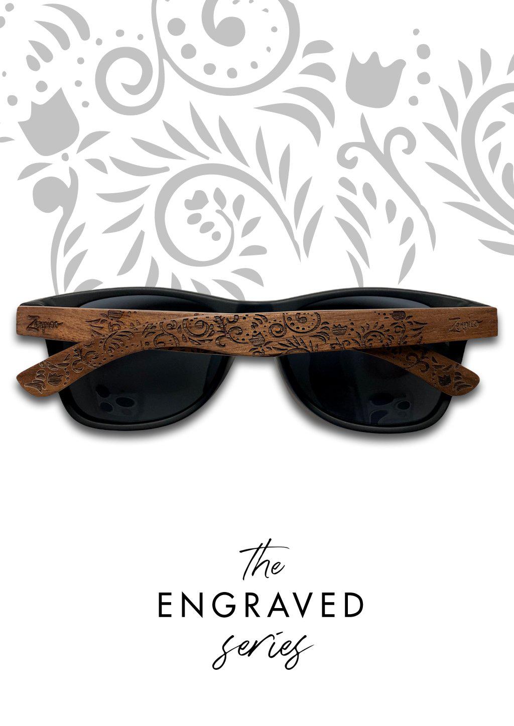 Eyewood engraved wooden sunglasses made from rosewood with a flower pattern, showcasing polarized black lenses and stainless steel hinges.
