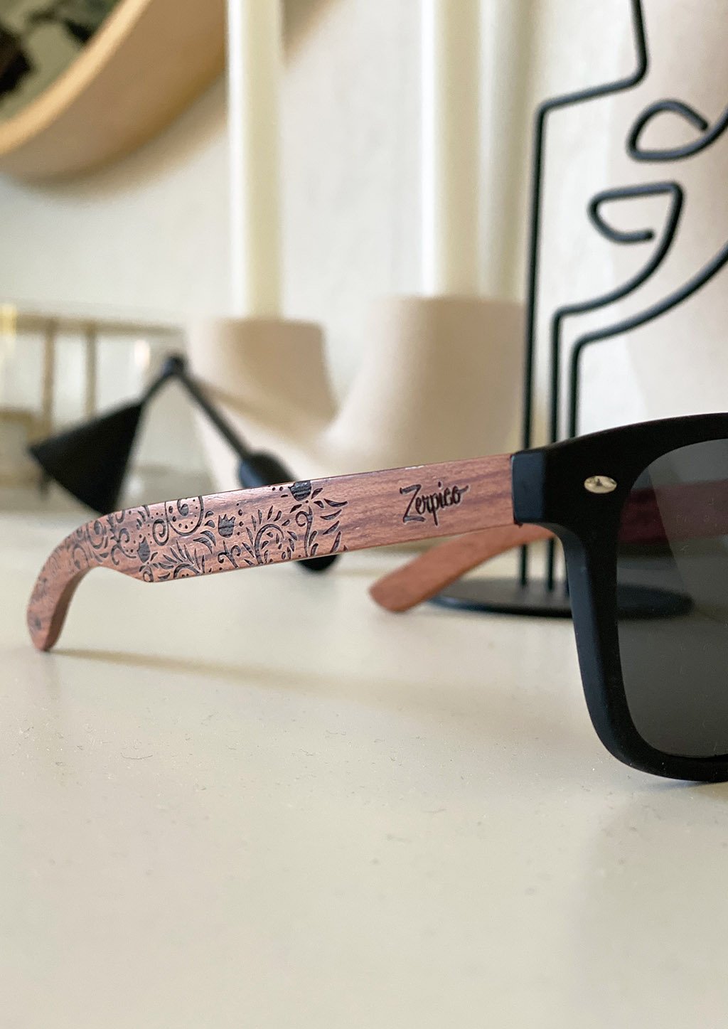 Eyewood engraved wooden sunglasses made from rosewood with a flower pattern, showcasing polarized black lenses and stainless steel hinges.