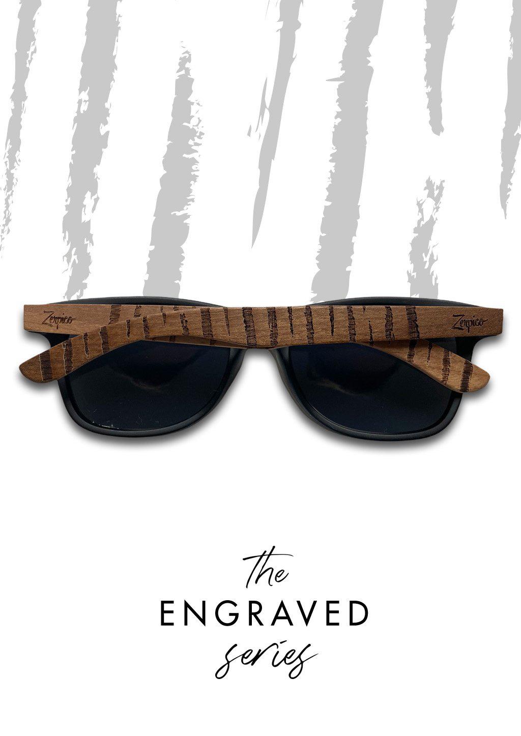 Eyewood Untamed engraved wooden sunglasses featuring unique tiger patterns on walnut temples and polarized black lenses.