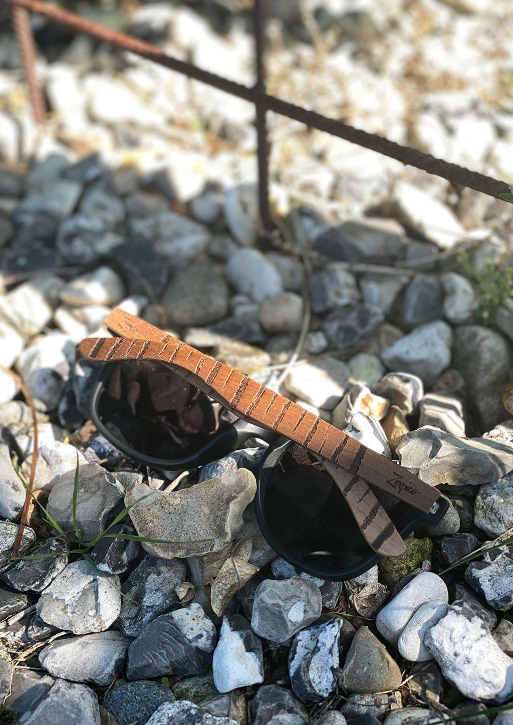 Eyewood Untamed engraved wooden sunglasses featuring unique tiger patterns on walnut temples and polarized black lenses.