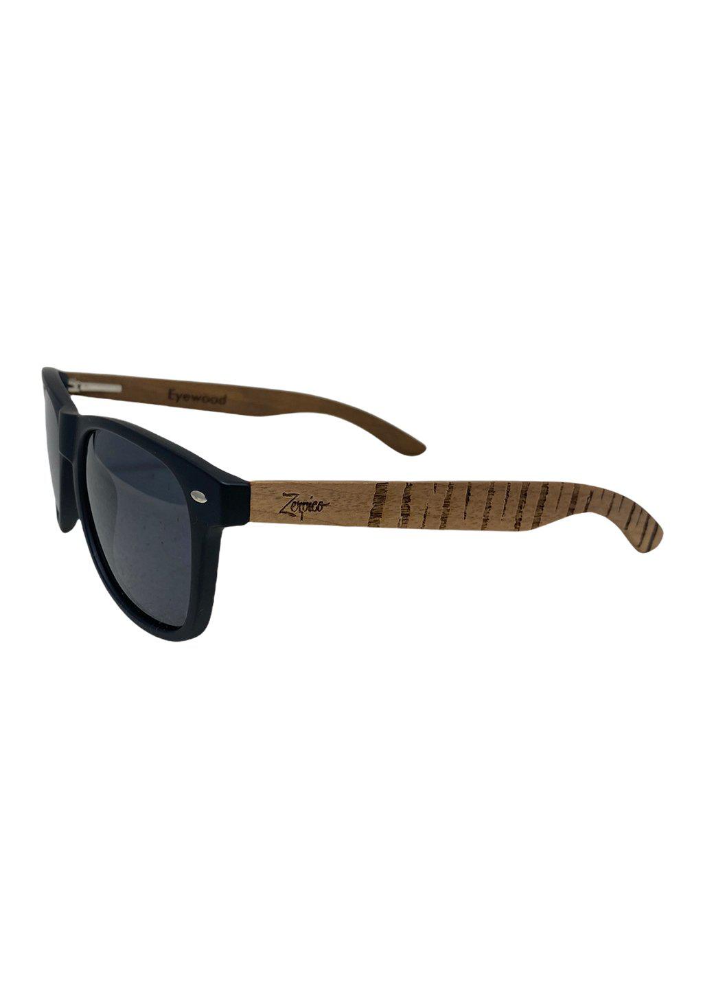 Eyewood Untamed engraved wooden sunglasses featuring unique tiger patterns on walnut temples and polarized black lenses.