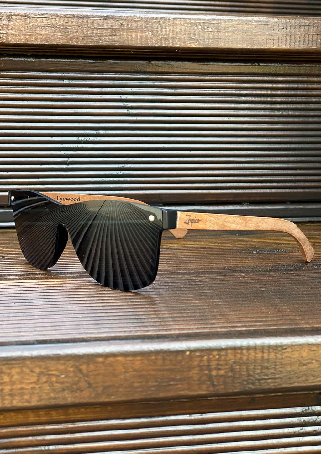 Eyewood Tomorrow - Taurus wooden sunglasses featuring rosewood frame and polarized black lenses, elegantly displayed in a handmade empress tree case.