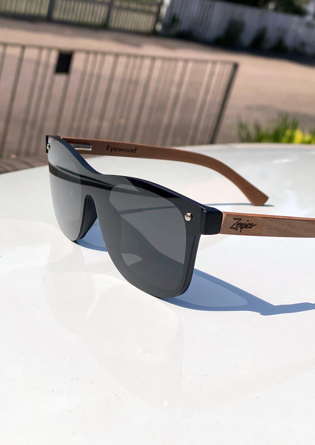 Eyewood Tomorrow - Taurus wooden sunglasses featuring rosewood frame and polarized black lenses, elegantly displayed in a handmade empress tree case.