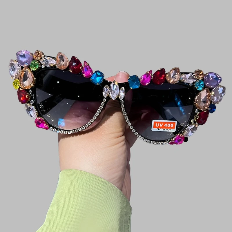 Hand designed bejeweled sunglasses with oversized cat eye style, featuring plastic frames and UV400 lenses.