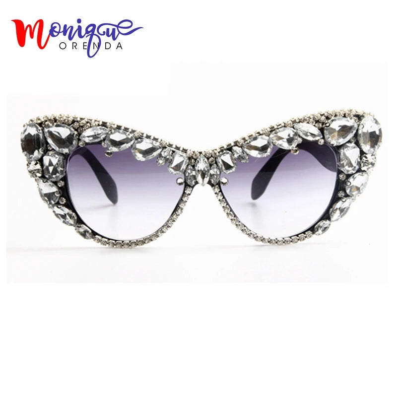 Hand designed bejeweled sunglasses with oversized cat eye style, featuring plastic frames and UV400 lenses.