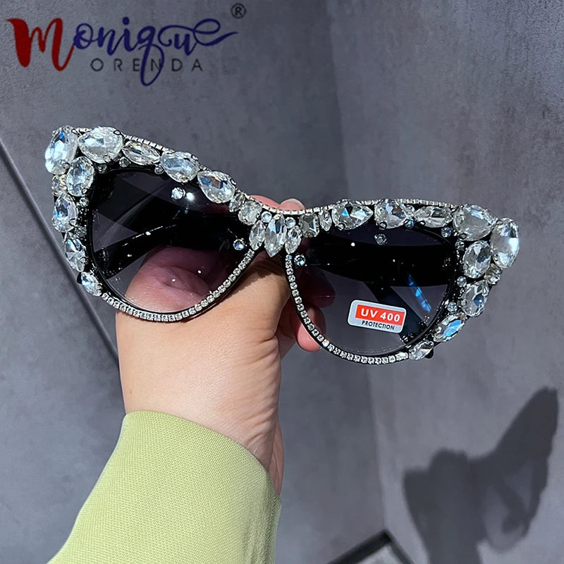 Hand designed bejeweled sunglasses with oversized cat eye style, featuring plastic frames and UV400 lenses.