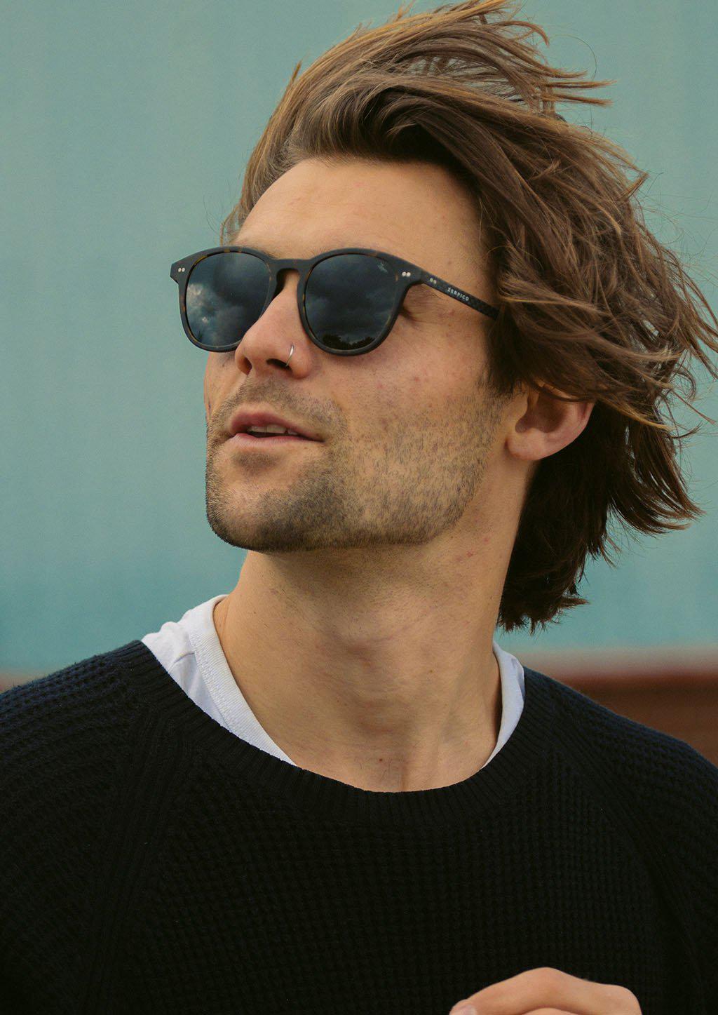 Hybrid Halo sunglasses featuring a round design with carbon fiber and acetate materials, showcasing various lens colors.