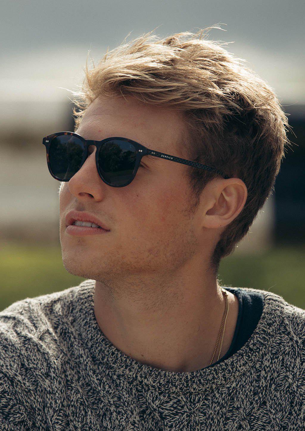 Hybrid Halo sunglasses featuring a round design with carbon fiber and acetate materials, showcasing various lens colors.