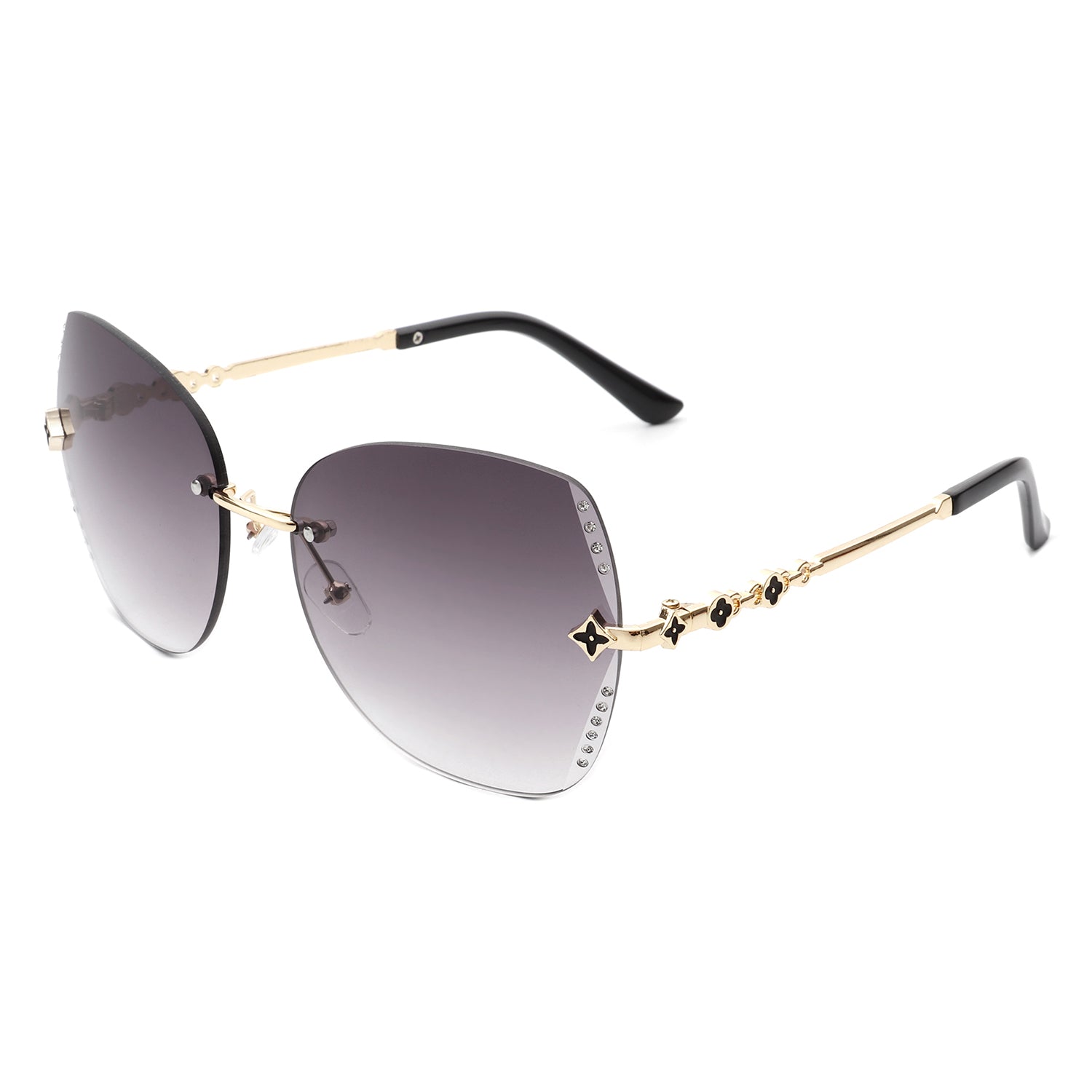 Kineticx Oversize Rimless Butterfly Sunglasses with tinted lenses and rhinestone accents, showcasing a stylish and glamorous design.