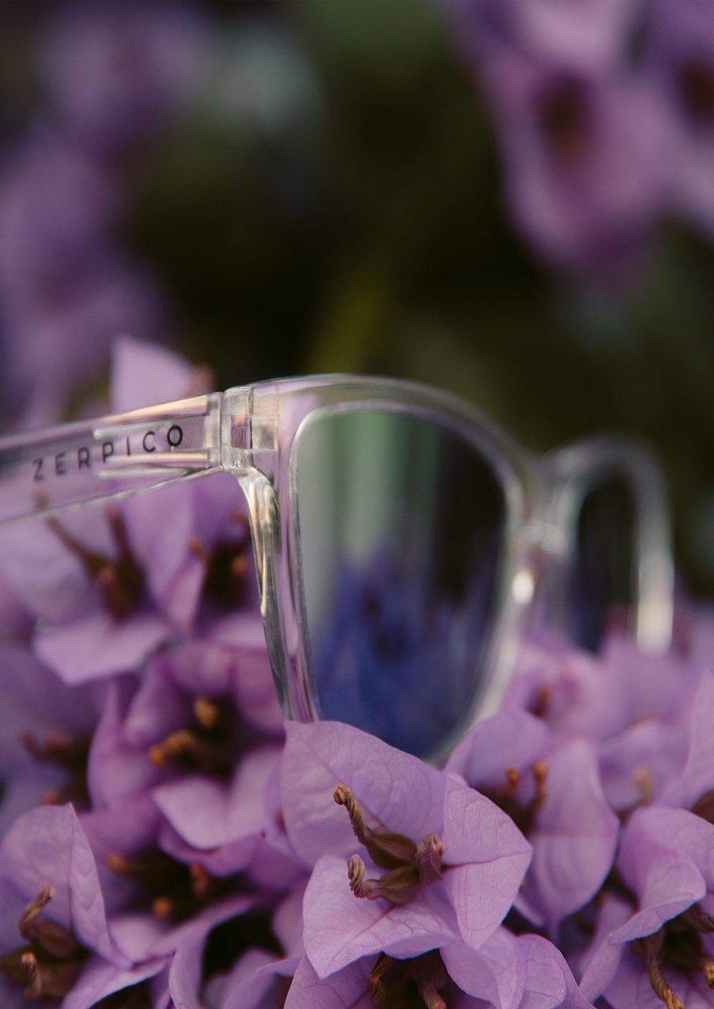 MOOD Wayfarer V2 - Lucid sunglasses featuring a transparent frame and purple mirror lenses, ideal for stylish outdoor adventures.