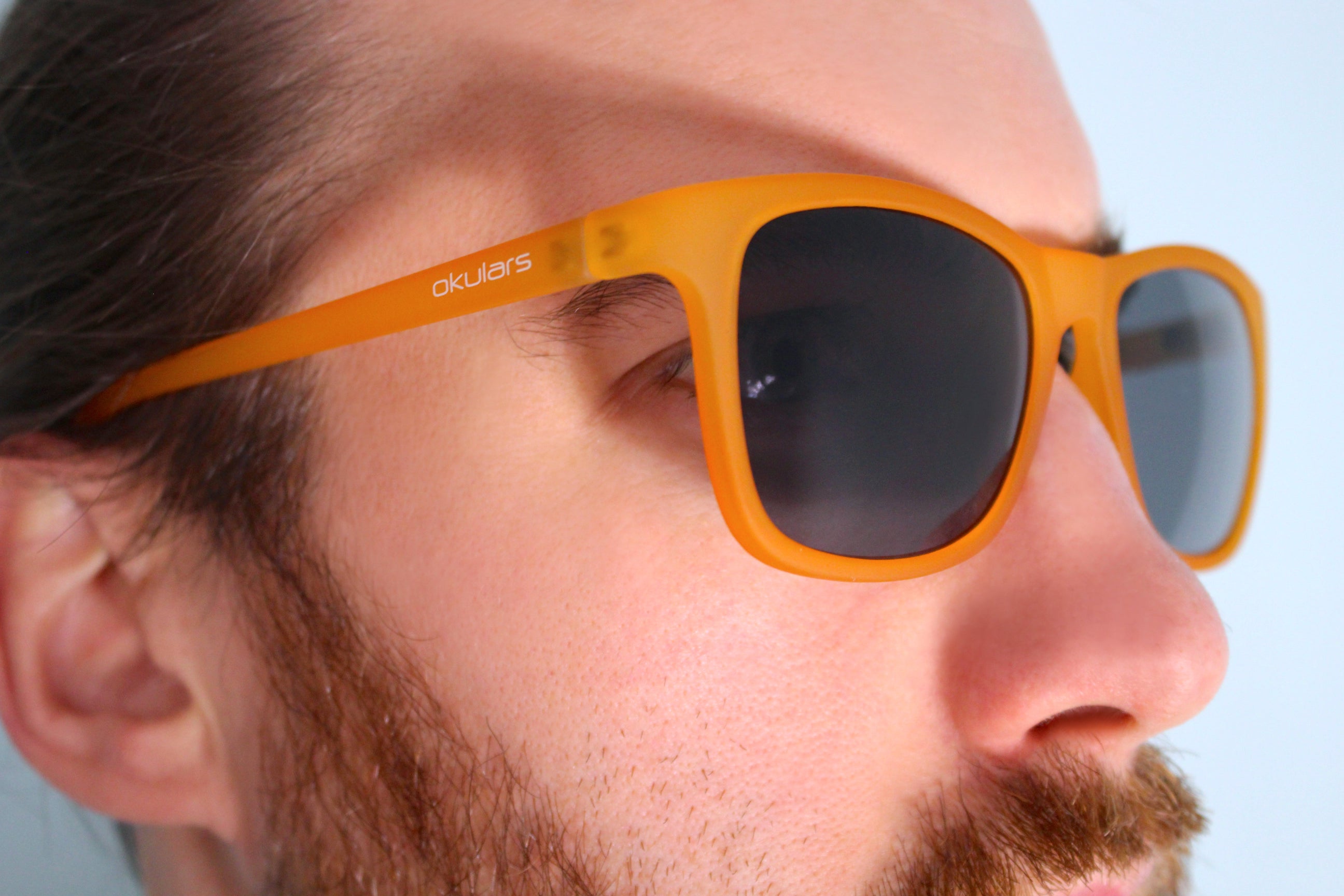 Okulars Eco Nordic Amber Black sunglasses with a matte finish, showcasing a stylish design made from recycled materials.