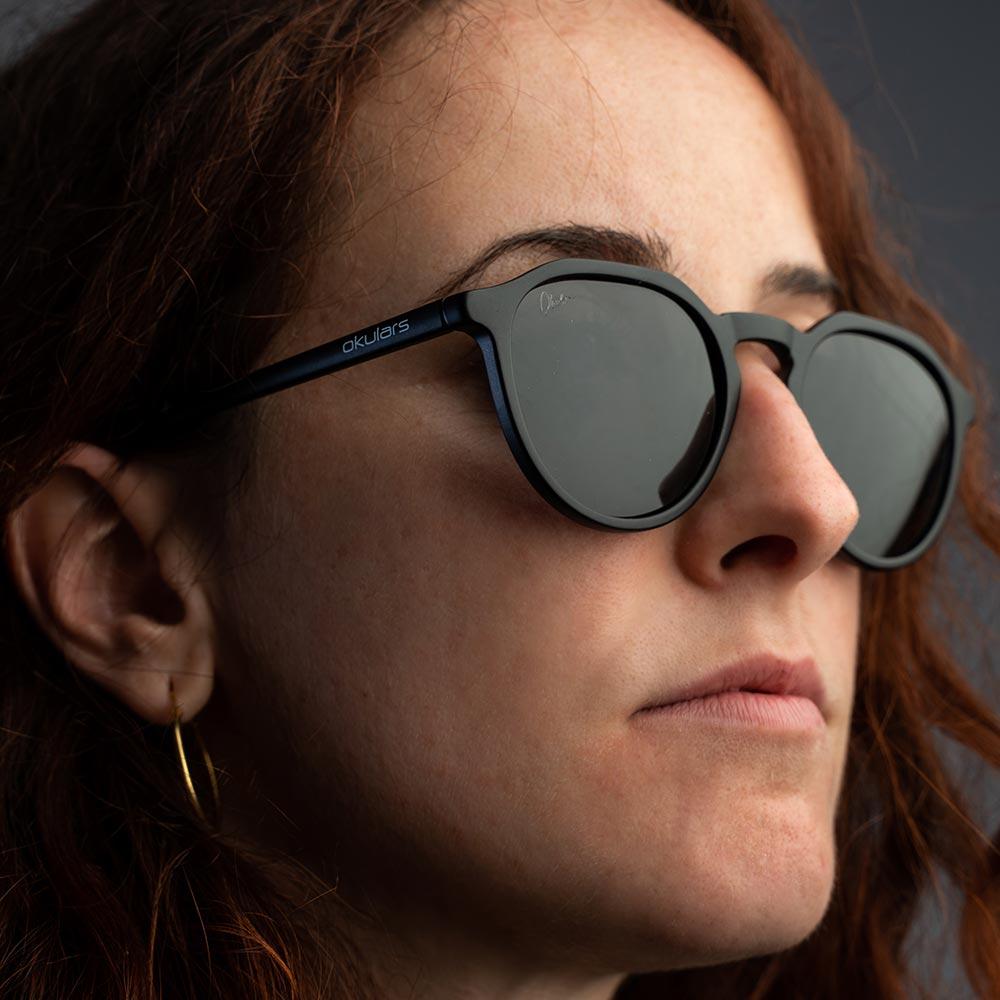 Okulars Eco Pacific Black sunglasses with a sleek matte finish, made from recycled materials, displayed on a neutral background.