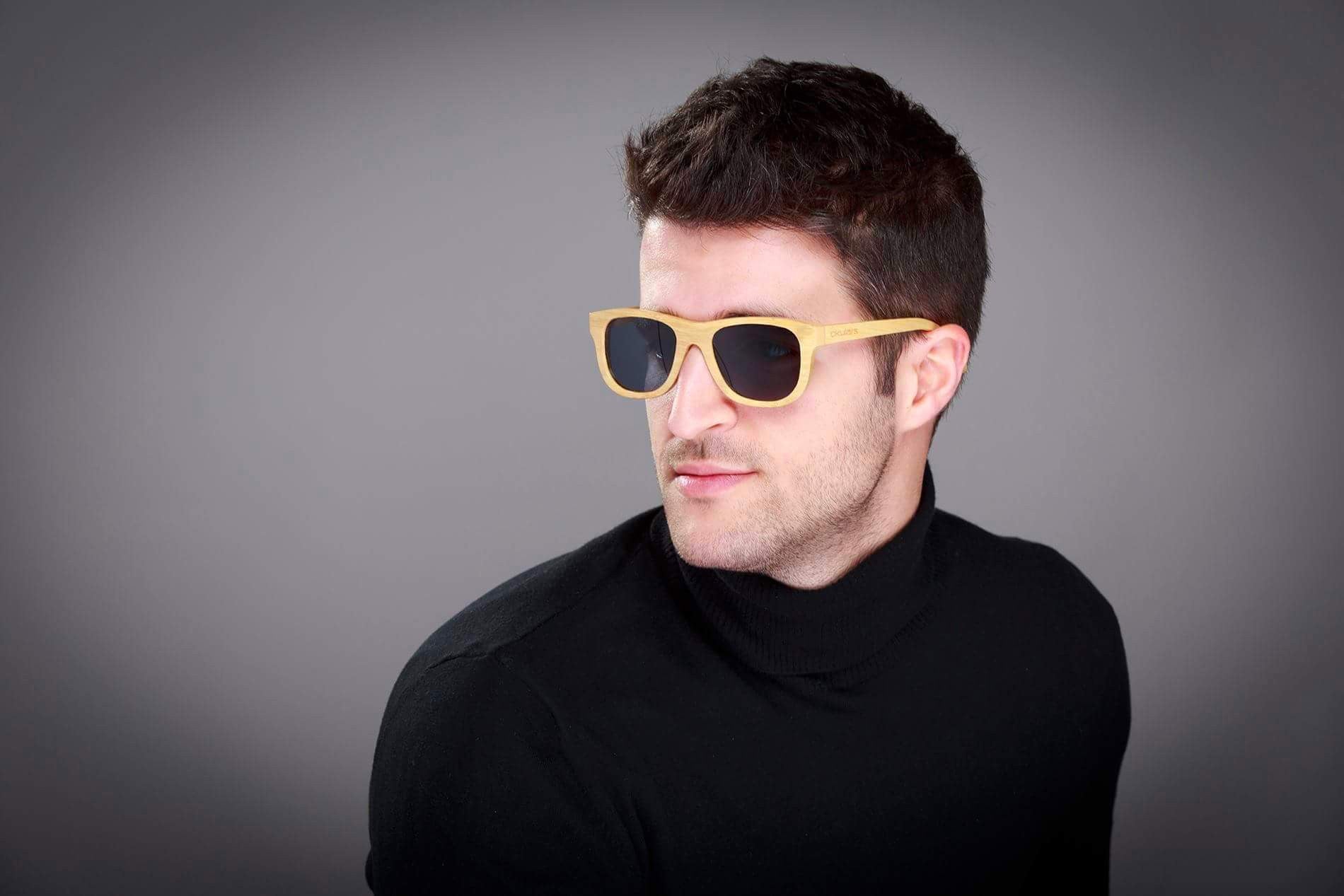 Okulars® Natural Bamboo sunglasses in Coal Black, featuring a lightweight bamboo frame and polarized lenses, displayed elegantly.