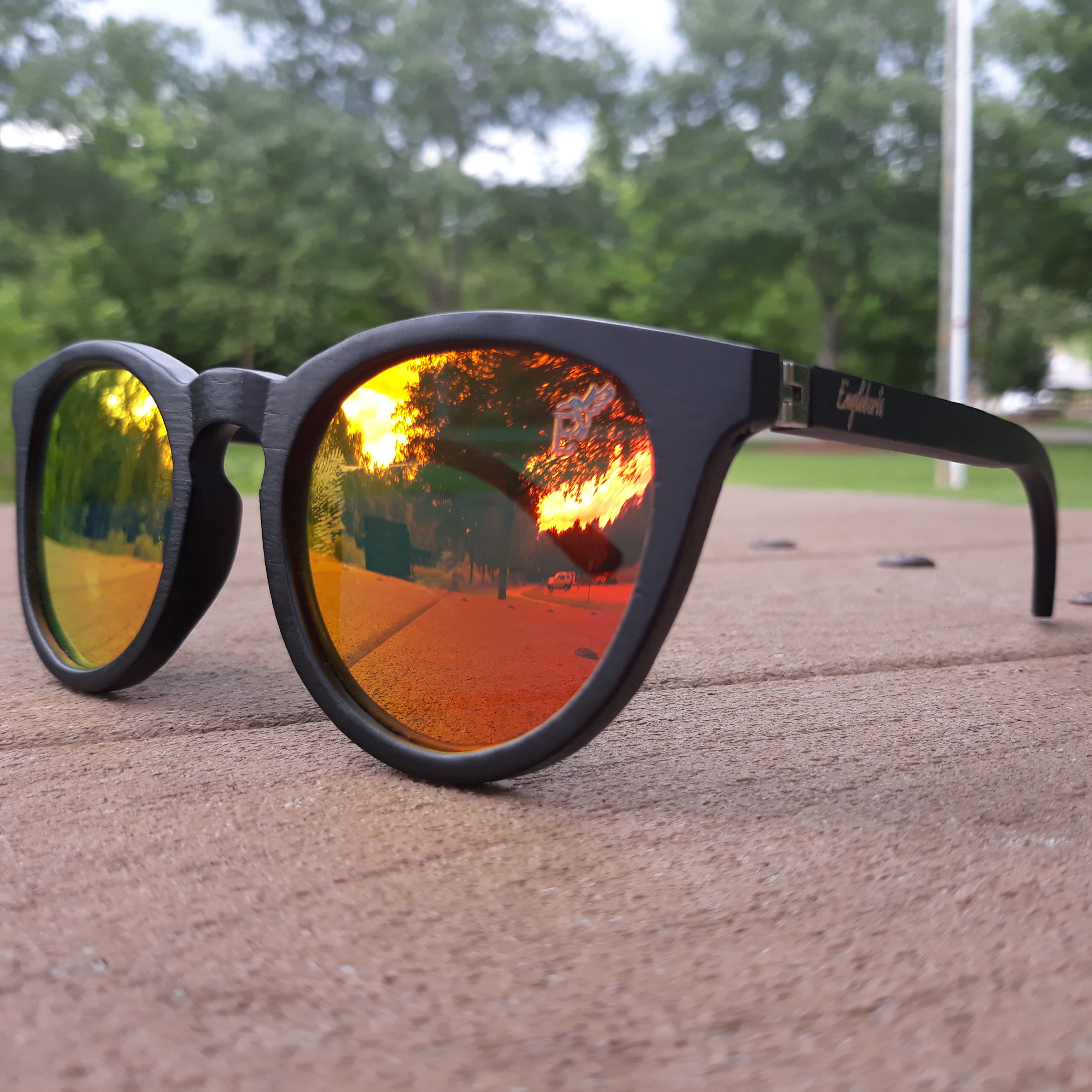 Engleberts Sunset Mirror Lenses Polarized sunglasses with black bamboo frame and protective case, showcasing stylish design and eco-friendly materials.