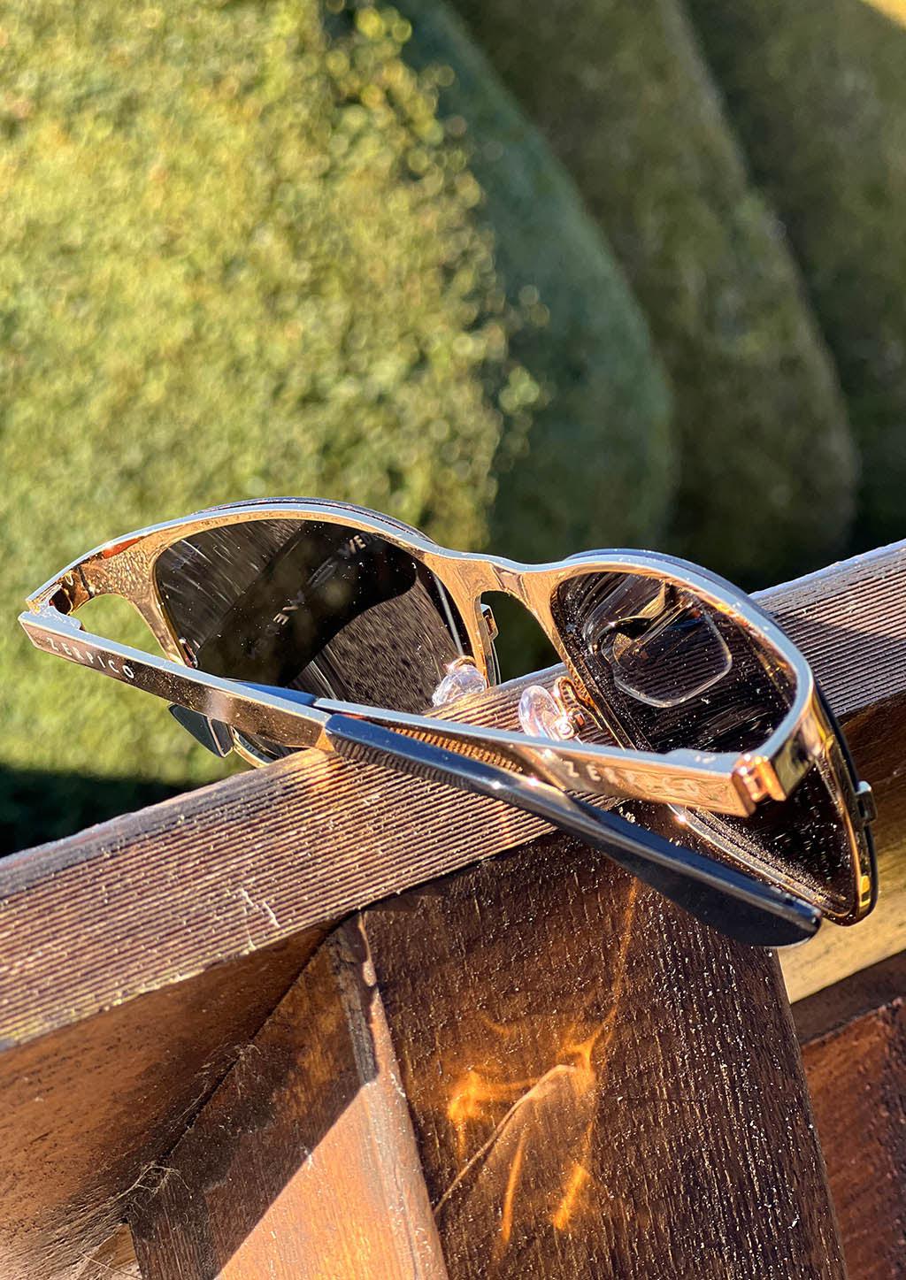 Luxurious Titanium Wayfarer Sunglasses plated with 24K gold, showcasing a stylish design and changeable lenses.