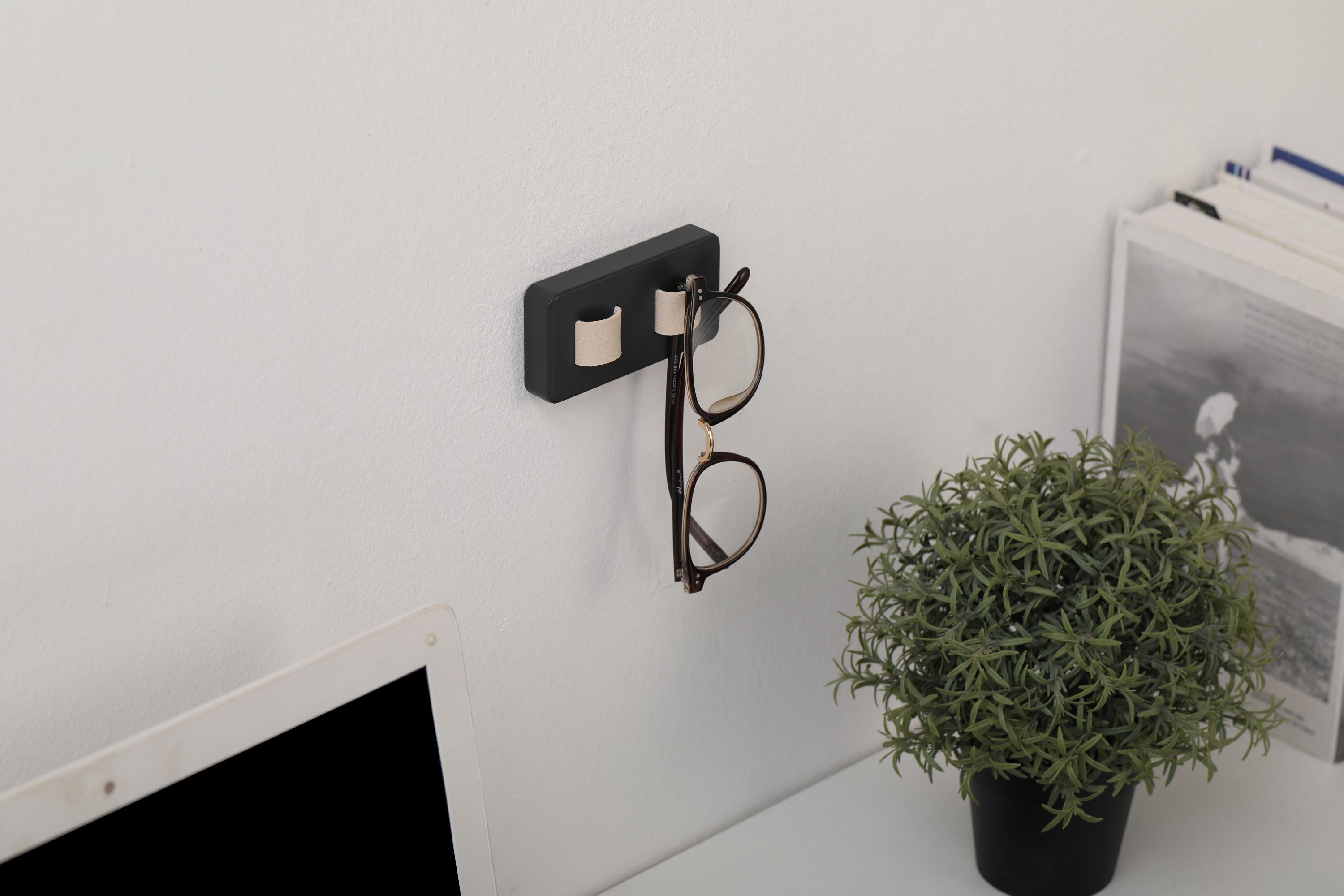 Wood Eye Glasses Holder mounted on a wall, featuring bamboo base and leather straps, elegantly displaying sunglasses and eyeglasses.