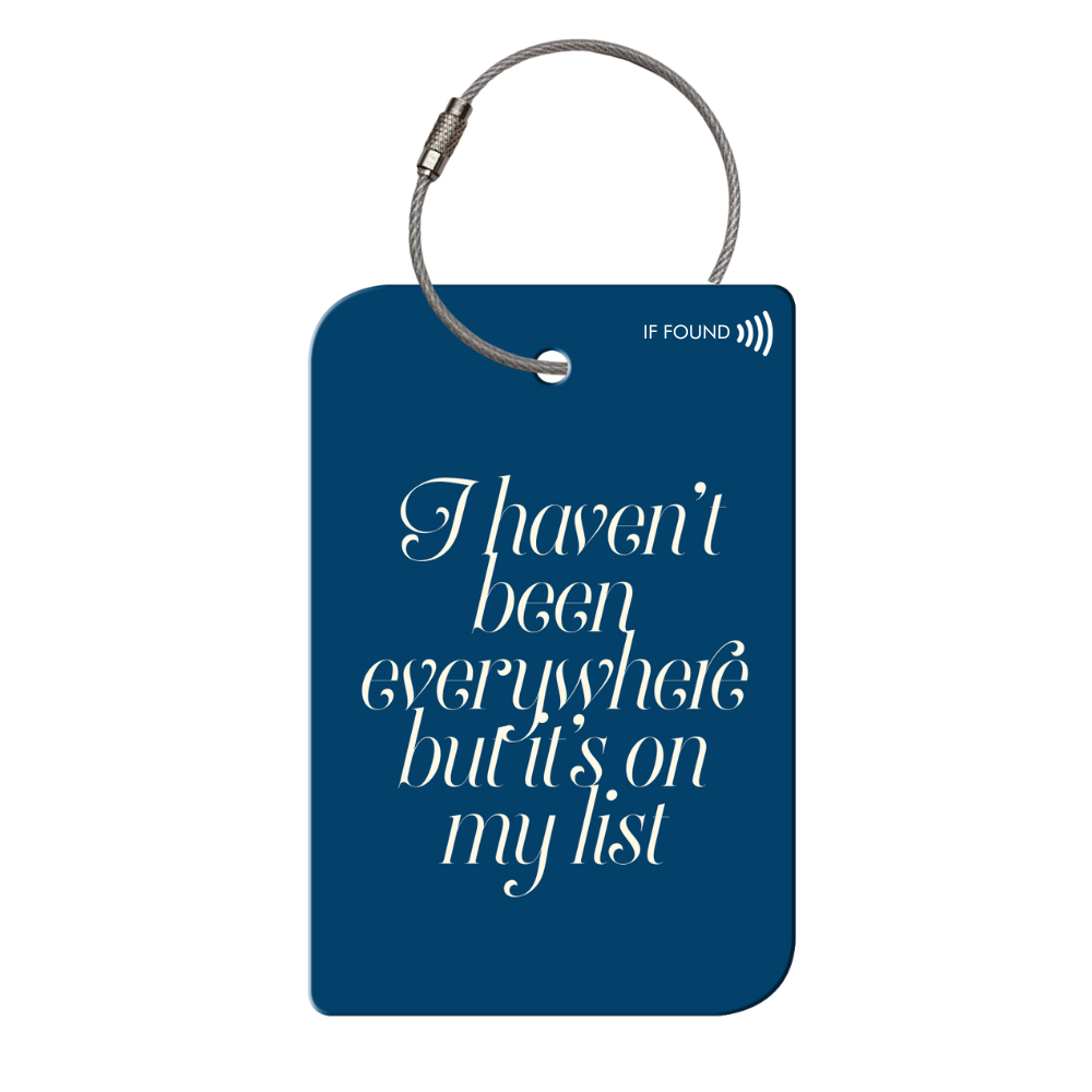 Retreev SMART Tag attached to a stylish bag, showcasing its durable stainless steel design and secure attachment.