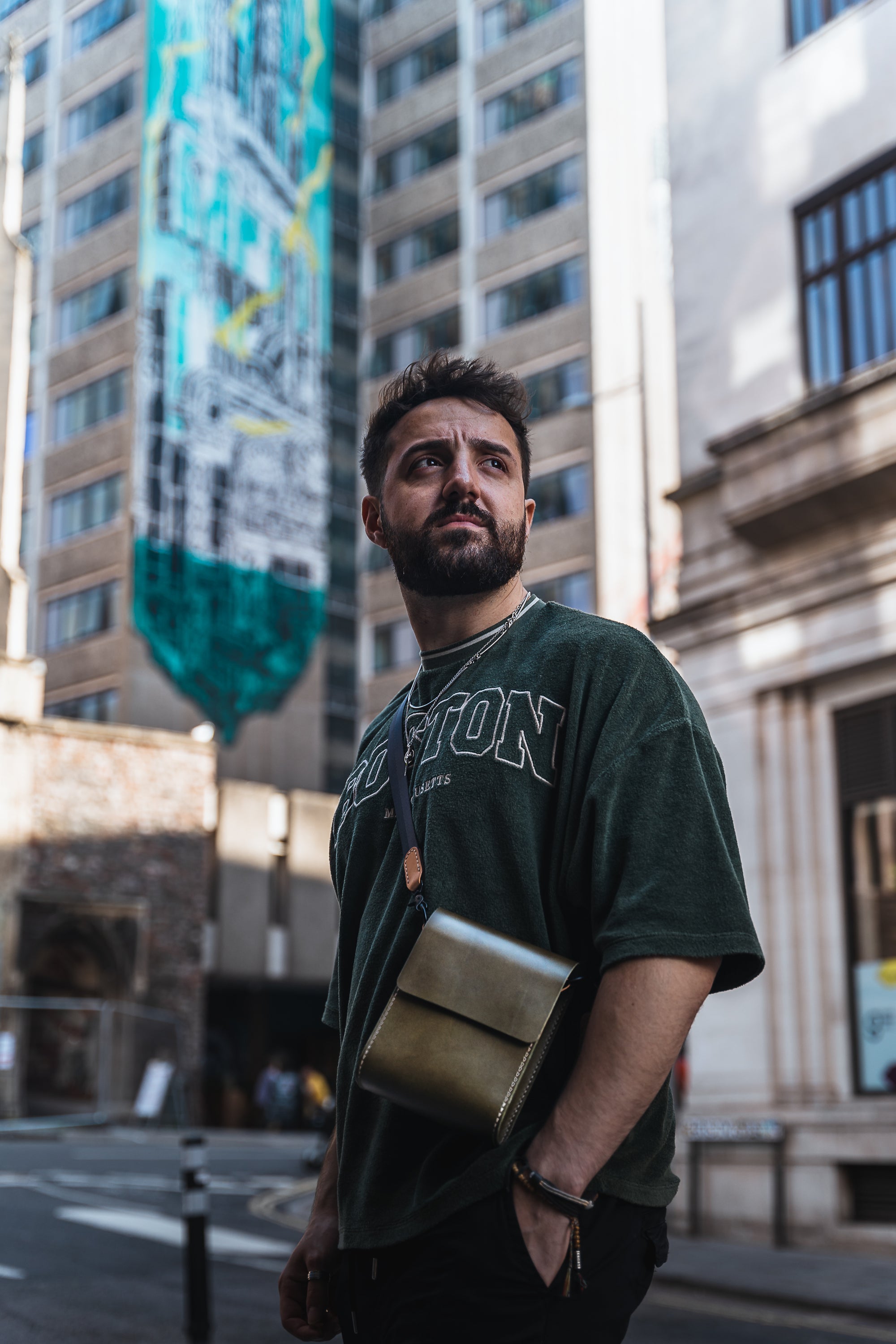 Giramondo Leather Crossbody Bag in Olive and Natural colors, showcasing full grain leather and matte black hardware.