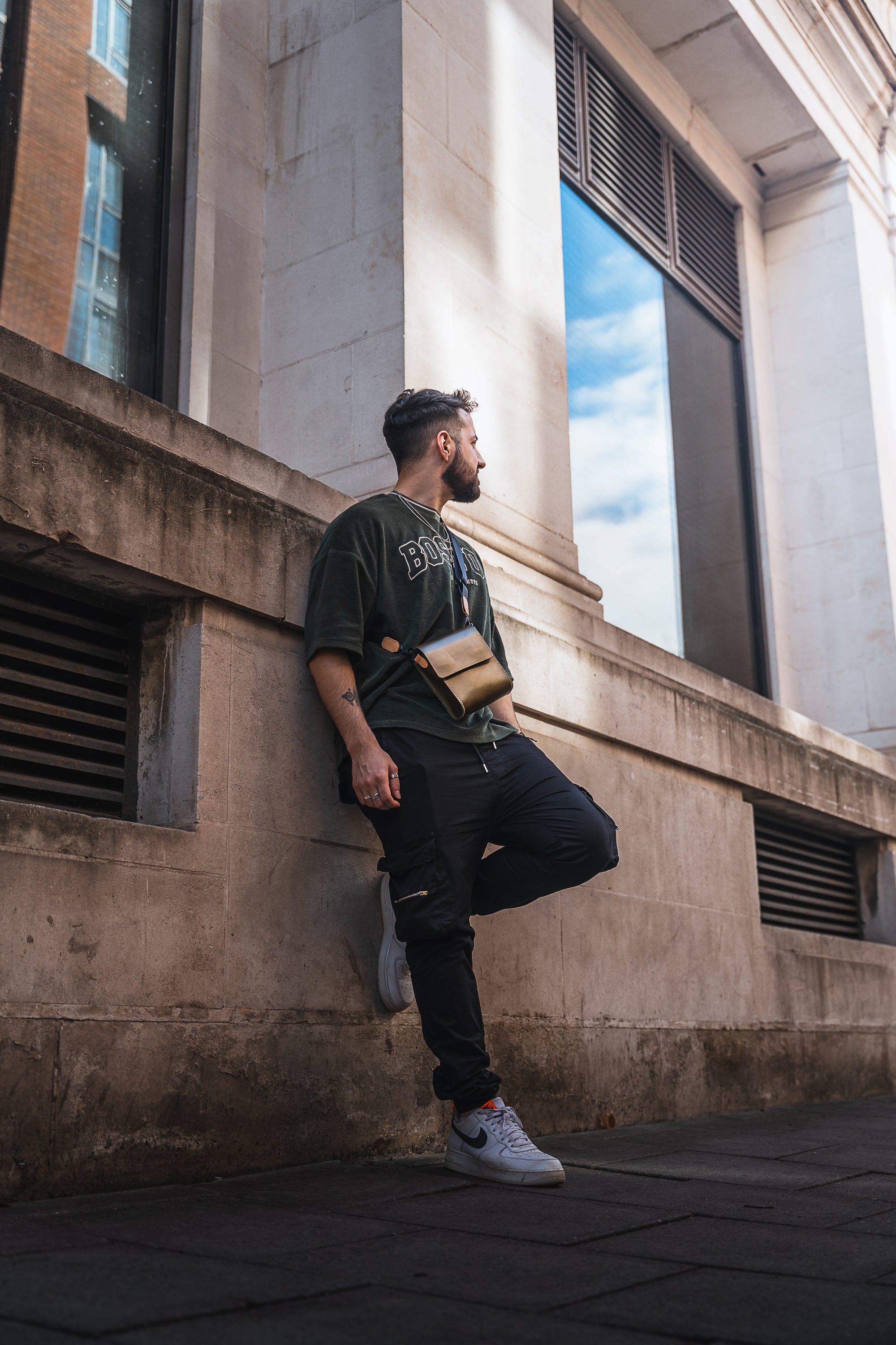 Giramondo Leather Crossbody Bag in Olive and Natural colors, showcasing full grain leather and matte black hardware.