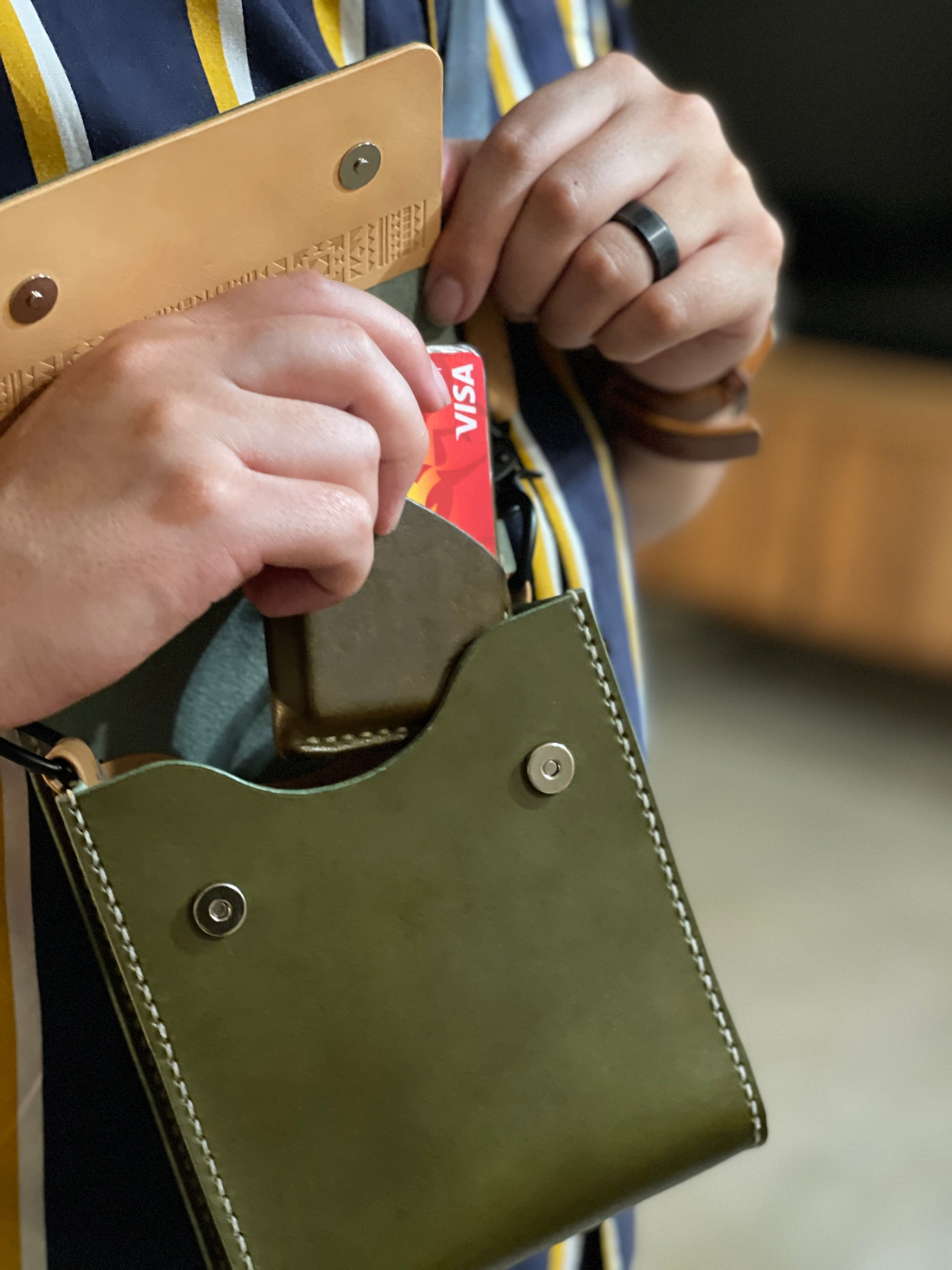 Giramondo Leather Crossbody Bag in Olive and Natural colors, showcasing full grain leather and matte black hardware.