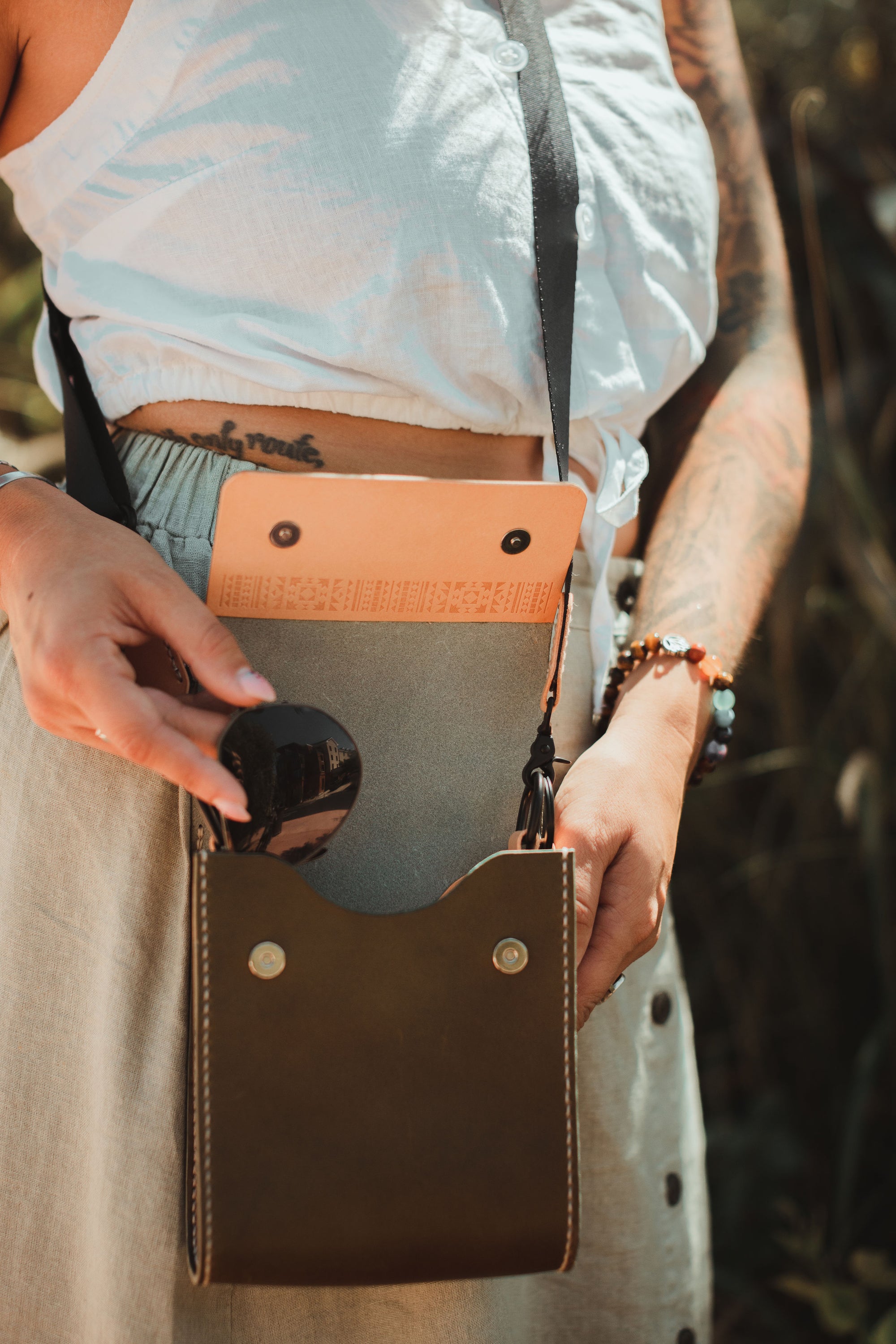 Giramondo Leather Crossbody Bag in Olive and Natural colors, showcasing full grain leather and matte black hardware.