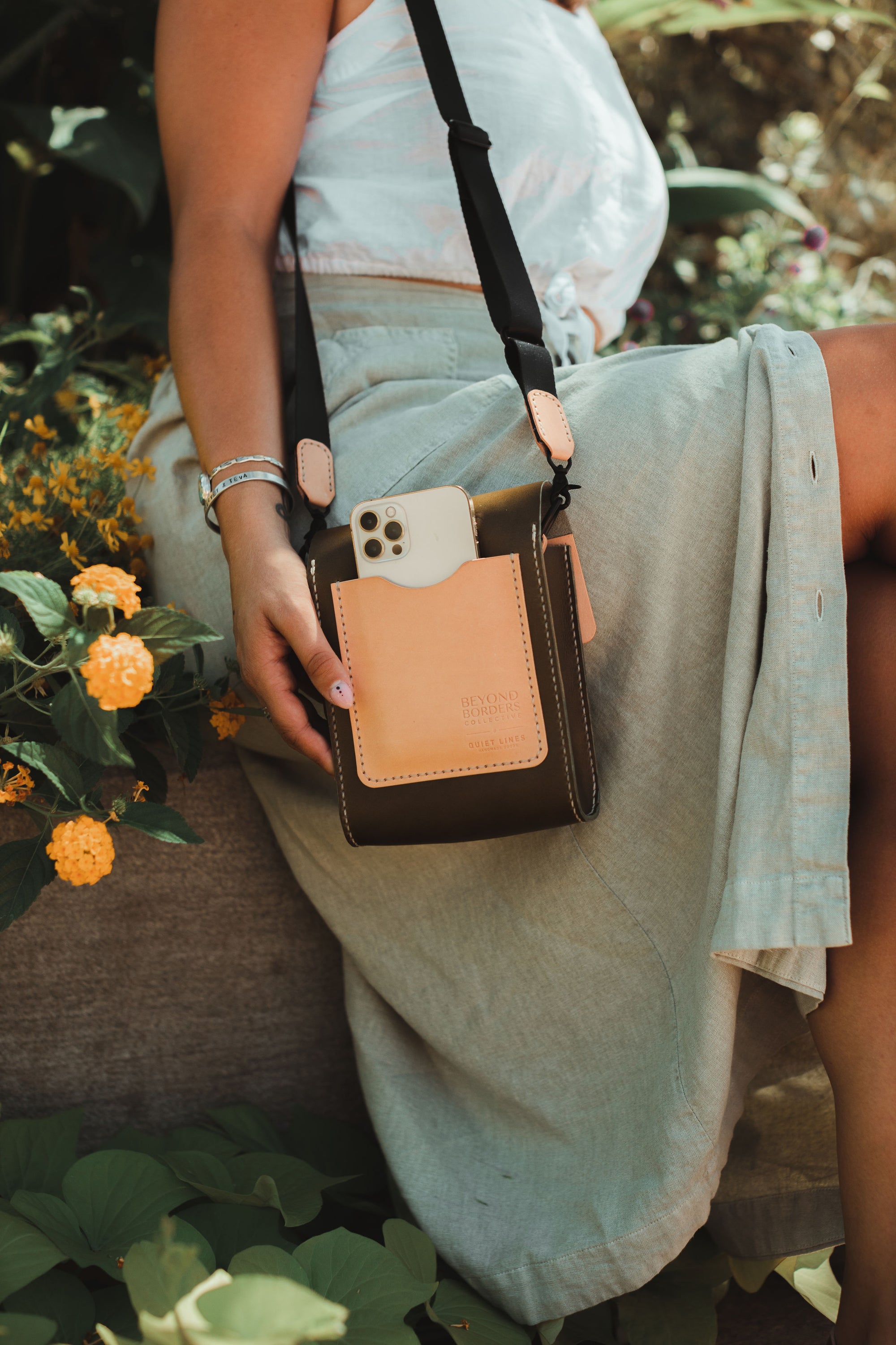 Giramondo Leather Crossbody Bag in Olive and Natural colors, showcasing full grain leather and matte black hardware.