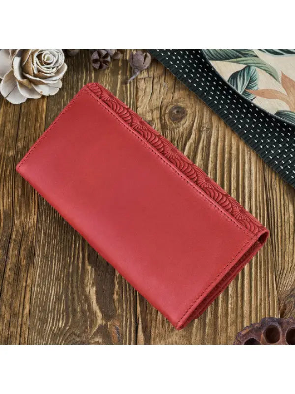 Natural leather women's wallet in red, green, and orange with geometric embossed pattern and compartments for cards and cash.