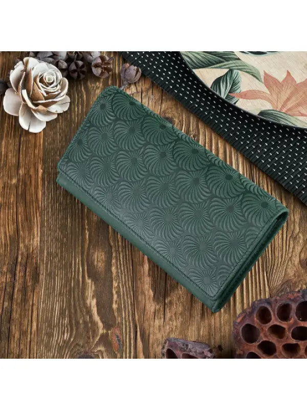 Natural leather women's wallet in red, green, and orange with geometric embossed pattern and compartments for cards and cash.