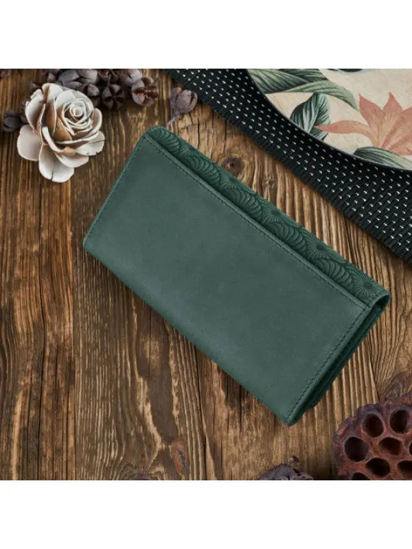 Natural leather women's wallet in red, green, and orange with geometric embossed pattern and compartments for cards and cash.