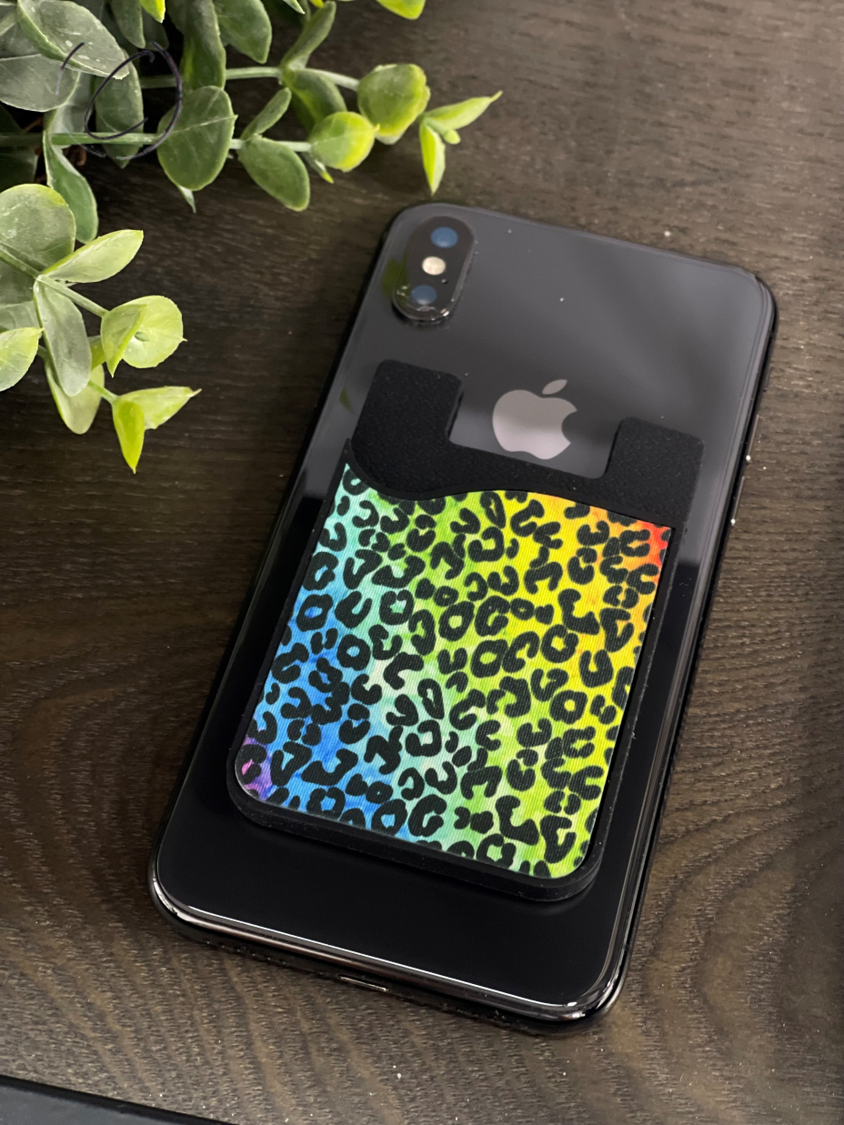 Rainbow Leopard Card Caddy Phone Wallet with removable microfiber screen cleaner, showcasing vibrant colors and stylish design.