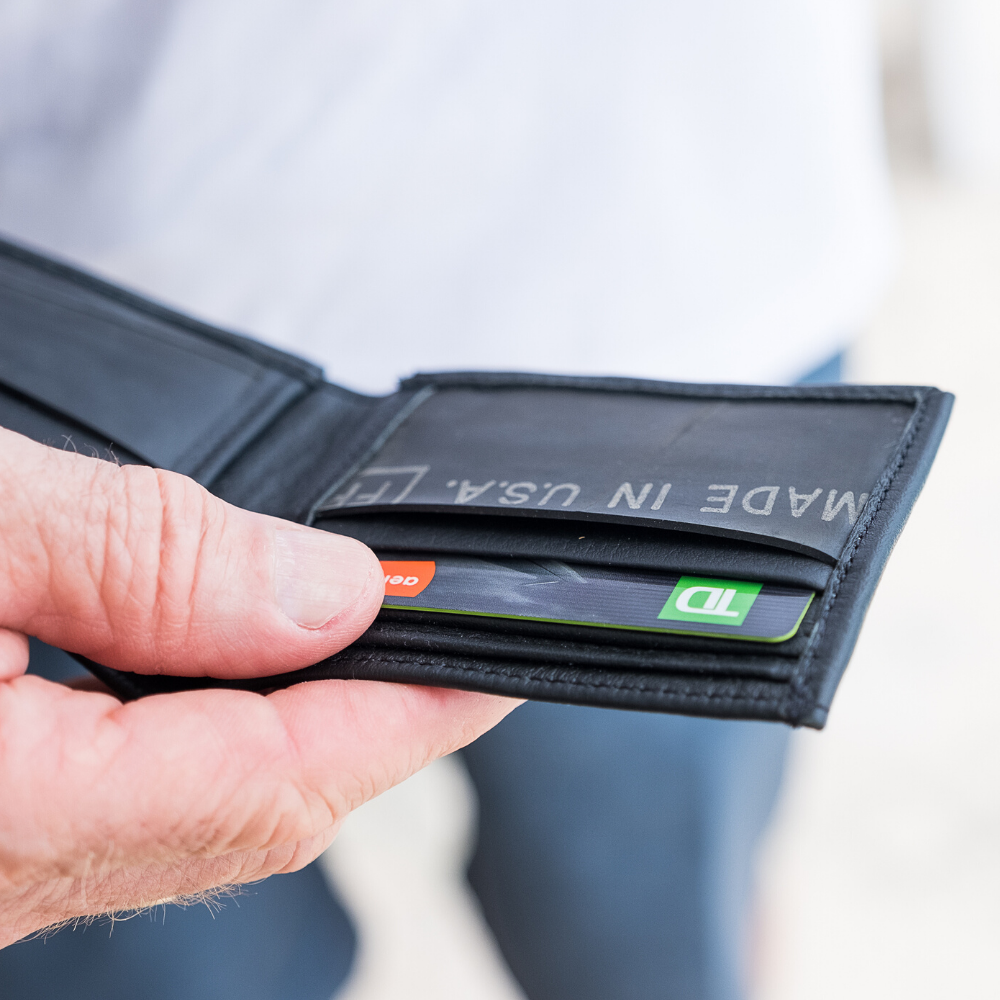 The Michel Bifold Leather Wallet showcasing its minimalist design, made from locally sourced leather and featuring recycled tire tube pockets.