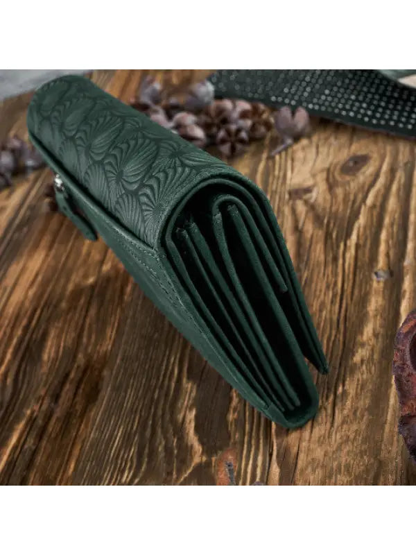 A vibrant and chic leather women's wallet showcasing premium leather craftsmanship, featuring a zipper and magnetic snap closure.