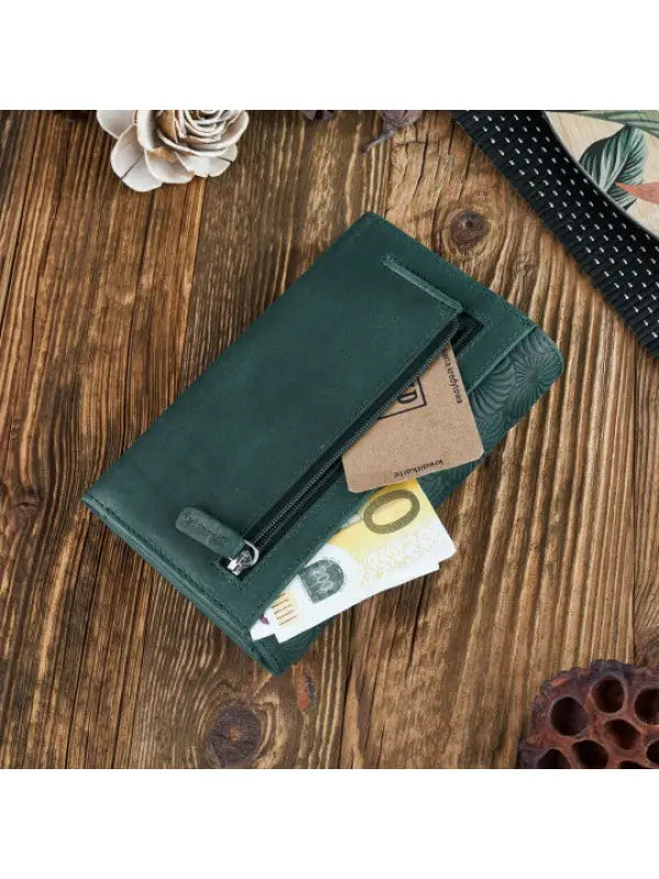 A vibrant and chic leather women's wallet showcasing premium leather craftsmanship, featuring a zipper and magnetic snap closure.