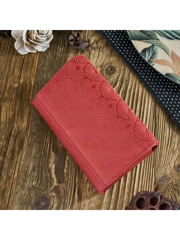 A vibrant and chic leather women's wallet showcasing premium leather craftsmanship, featuring a zipper and magnetic snap closure.