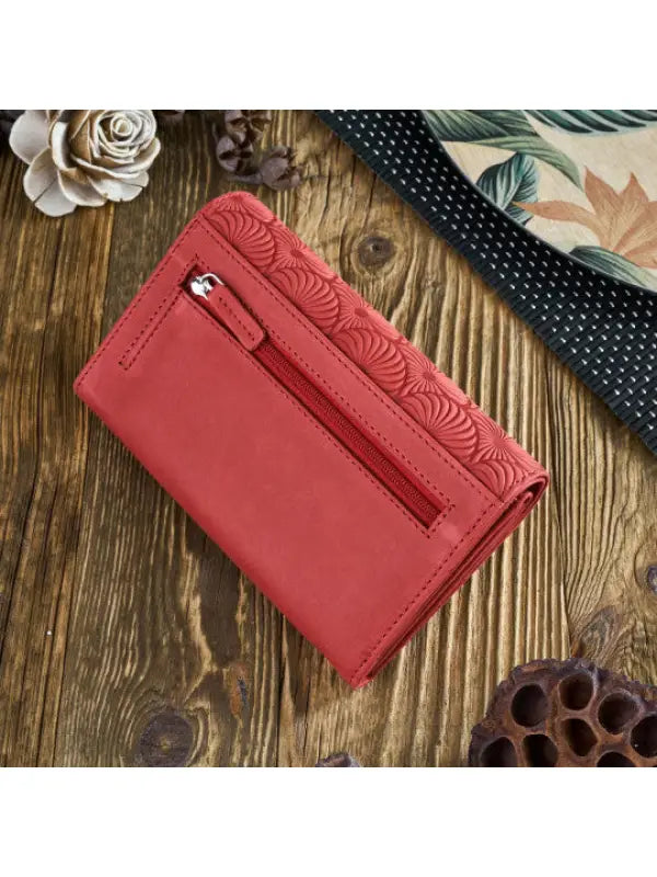 A vibrant and chic leather women's wallet showcasing premium leather craftsmanship, featuring a zipper and magnetic snap closure.