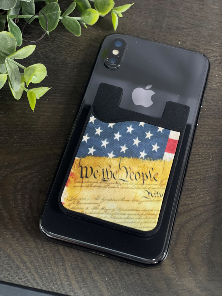 We The People Card Caddy Phone Wallet in silicone, holding credit cards and featuring a microfiber screen cleaner.