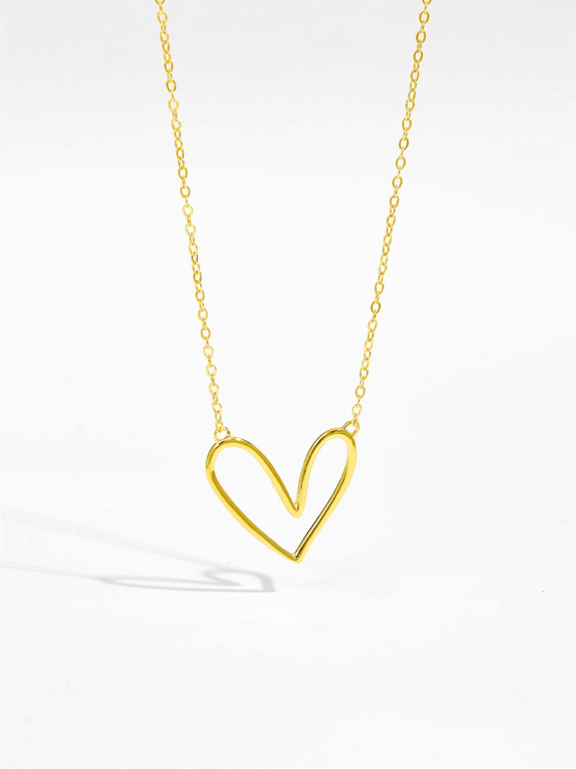 A delicate 925 sterling silver heart pendant necklace with a platinum and 18K gold plating, showcasing its elegant design.
