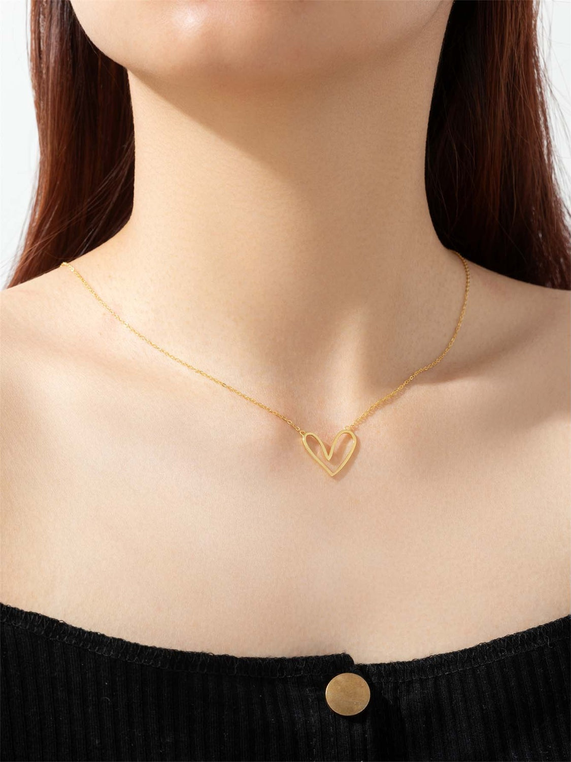 A delicate 925 sterling silver heart pendant necklace with a platinum and 18K gold plating, showcasing its elegant design.