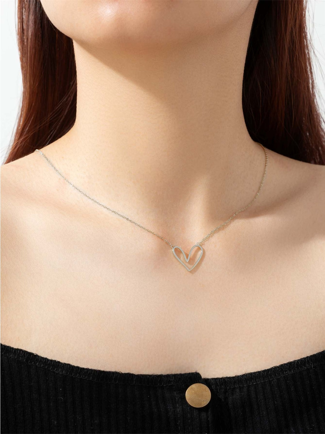 A delicate 925 sterling silver heart pendant necklace with a platinum and 18K gold plating, showcasing its elegant design.