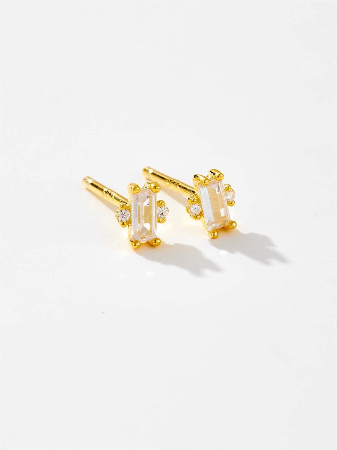A pair of elegant 925 sterling silver stud earrings featuring sparkling zircon stones, showcasing their luxurious design and quality craftsmanship.