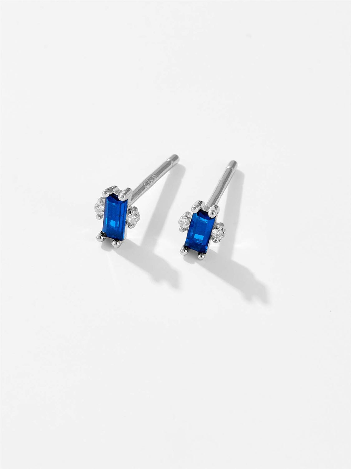 A pair of elegant 925 sterling silver stud earrings featuring sparkling zircon stones, showcasing their luxurious design and quality craftsmanship.