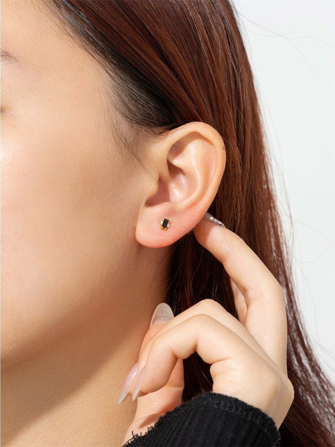 A pair of elegant 925 sterling silver stud earrings featuring sparkling zircon stones, showcasing their luxurious design and quality craftsmanship.