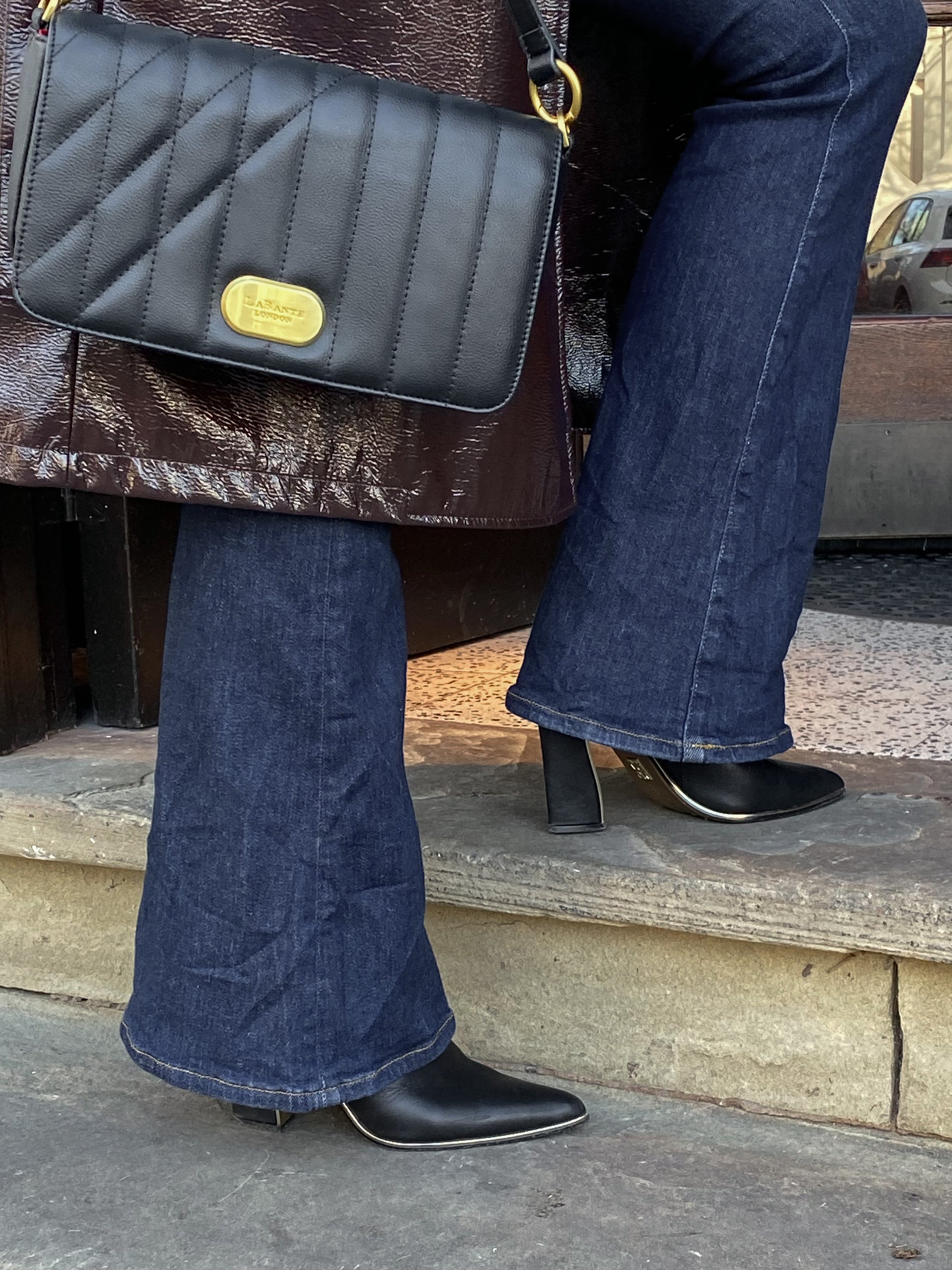 Aurora Crossbody Bag in Black featuring unique art-inspired design and adjustable straps.