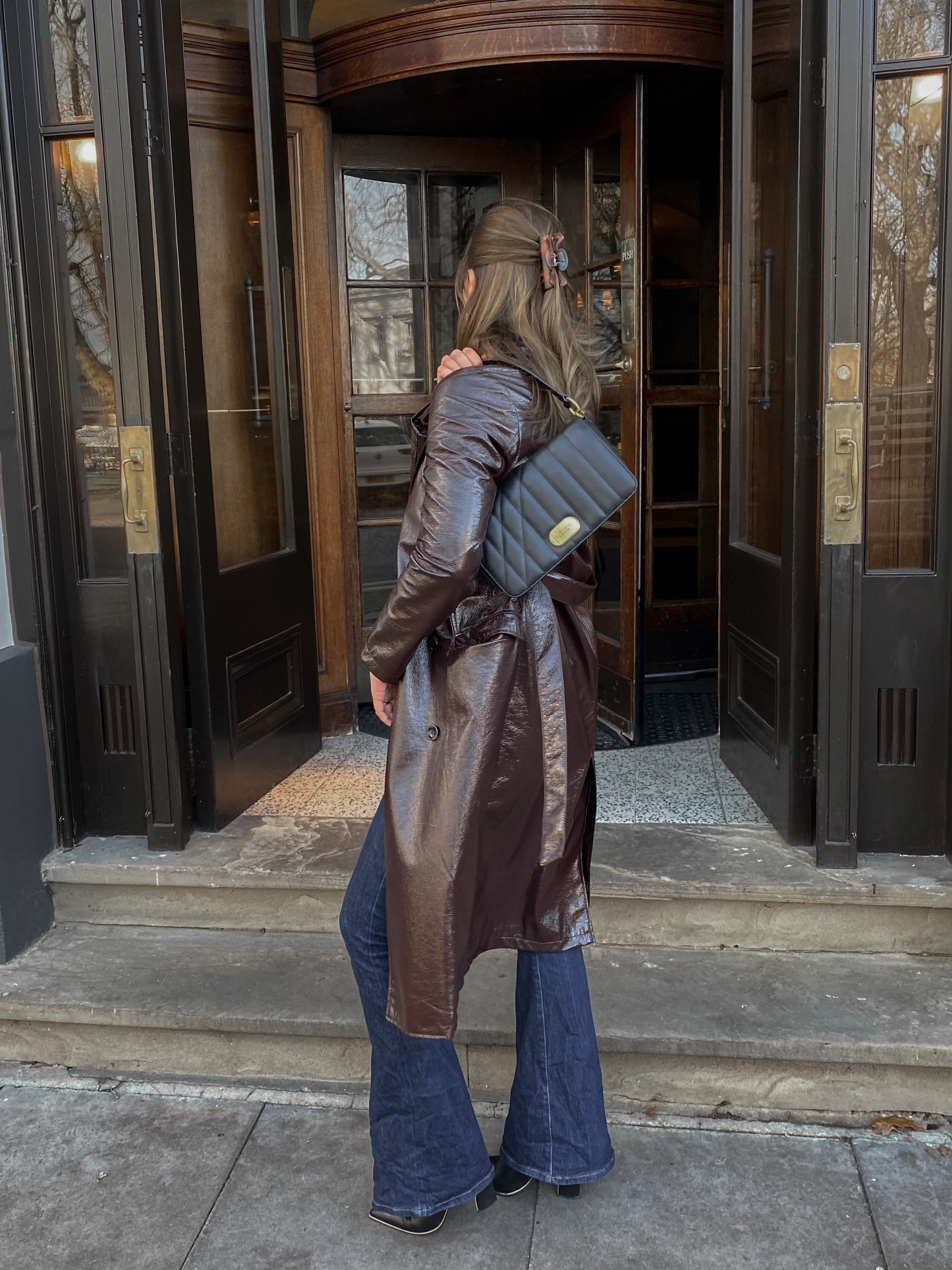 Aurora Crossbody Bag in Black featuring unique art-inspired design and adjustable straps.