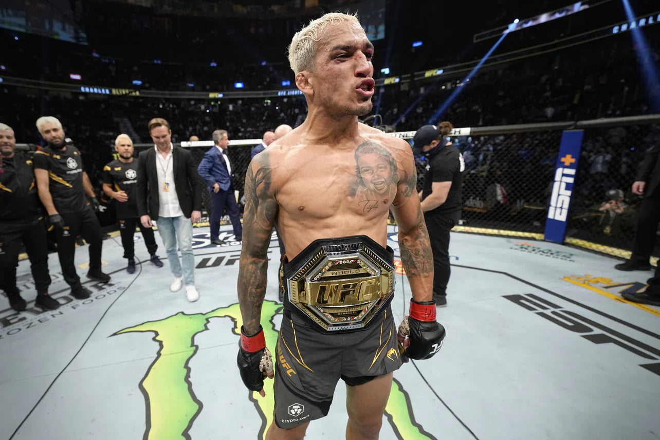 CHARLES OLIVEIRA SIGNED UFC LEGACY CHAMPIONSHIP REPLICA BELT featuring Charles Oliveira's autograph, showcasing intricate details and design.