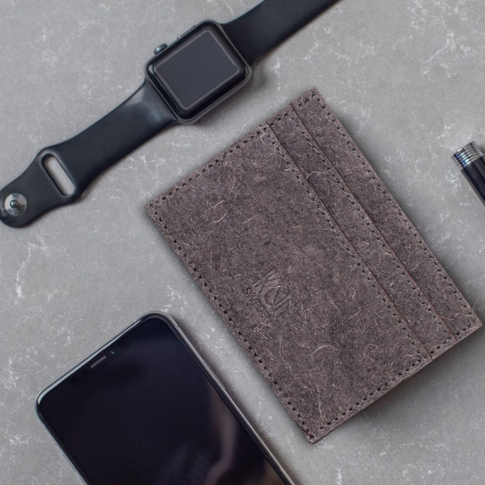 Dark grey Coconut Leather Card Holder with four card slots and inner pocket, showcasing its minimalist design and eco-friendly material.