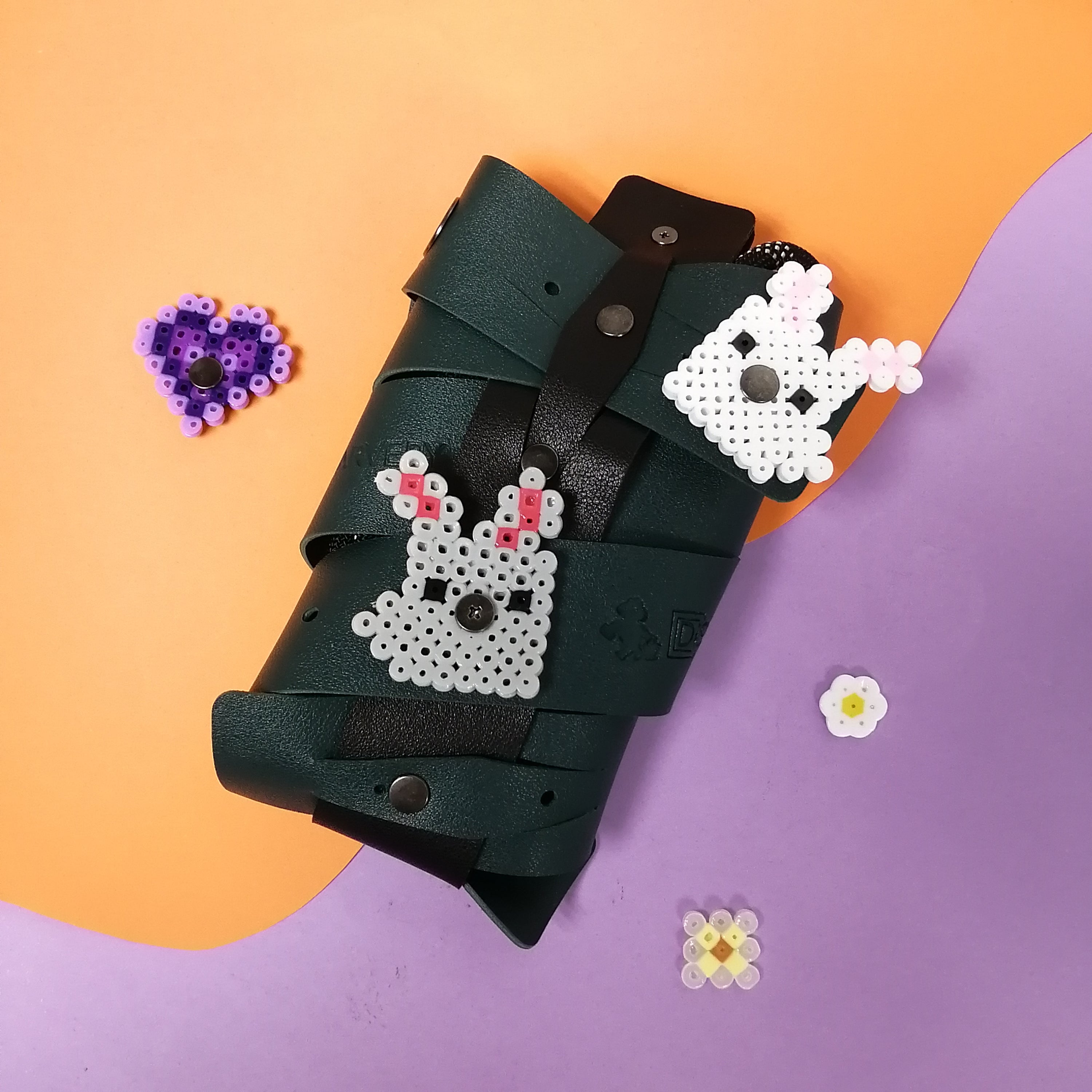 A colorful Creative Brooch designed to enhance mobile bags, featuring various colors and unique designs.