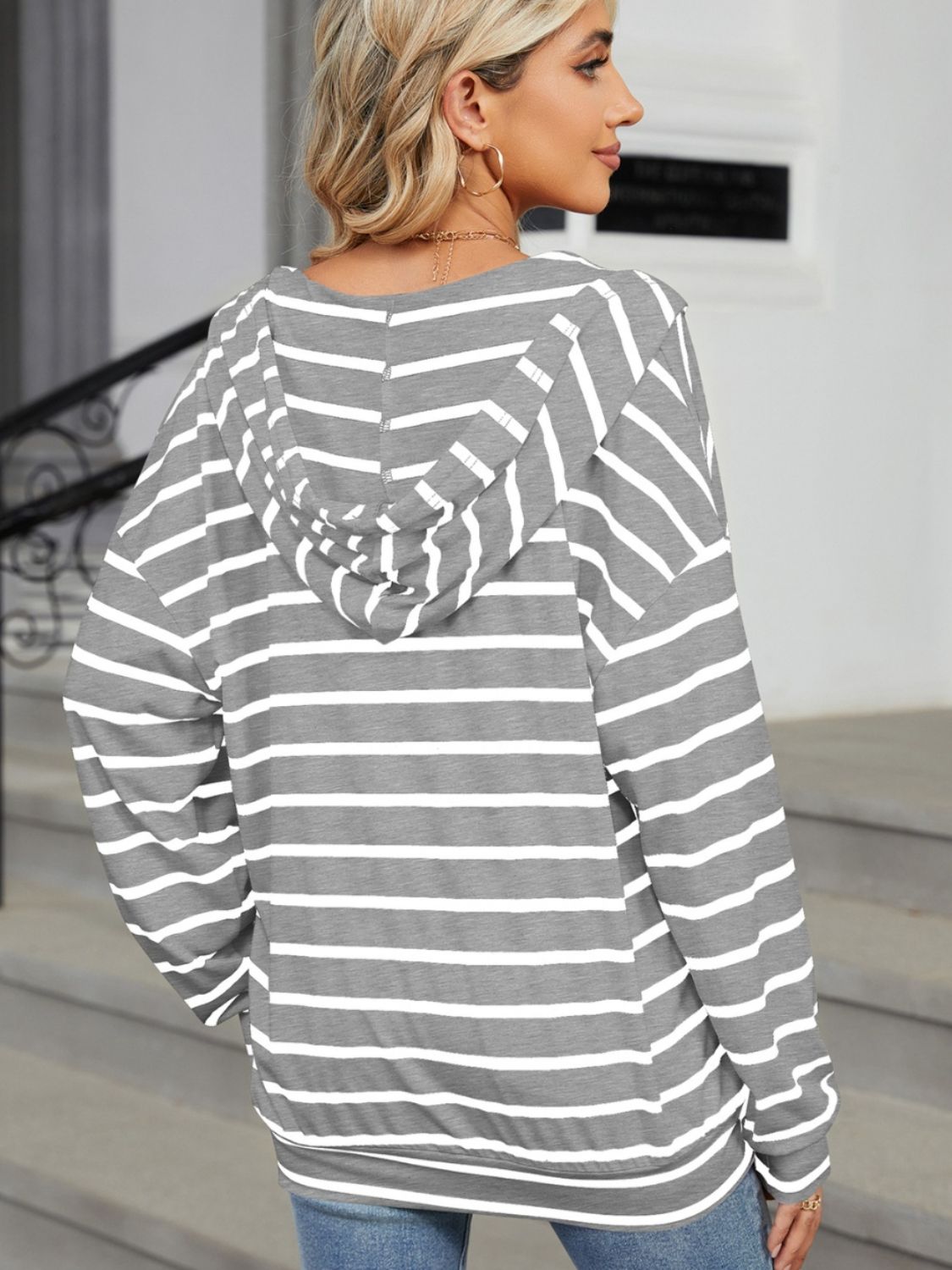 A stylish drawstring striped long sleeve hoodie in various colors, showcasing its soft fabric and adjustable drawstring feature.