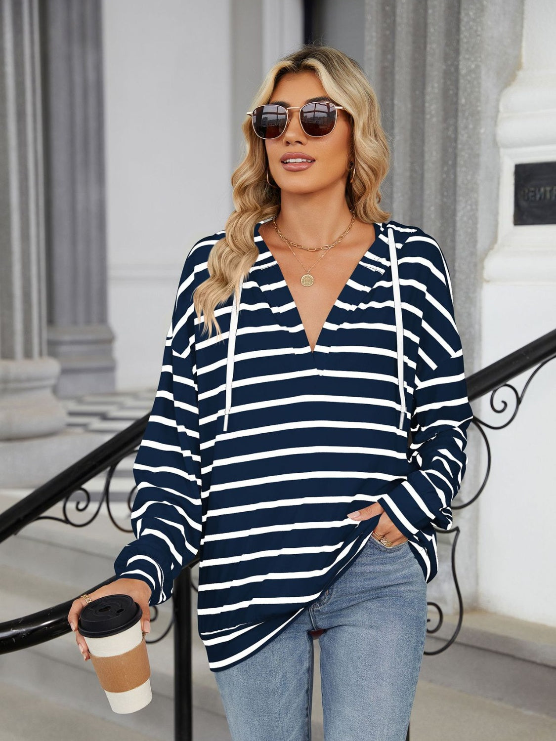 A stylish drawstring striped long sleeve hoodie in various colors, showcasing its soft fabric and adjustable drawstring feature.