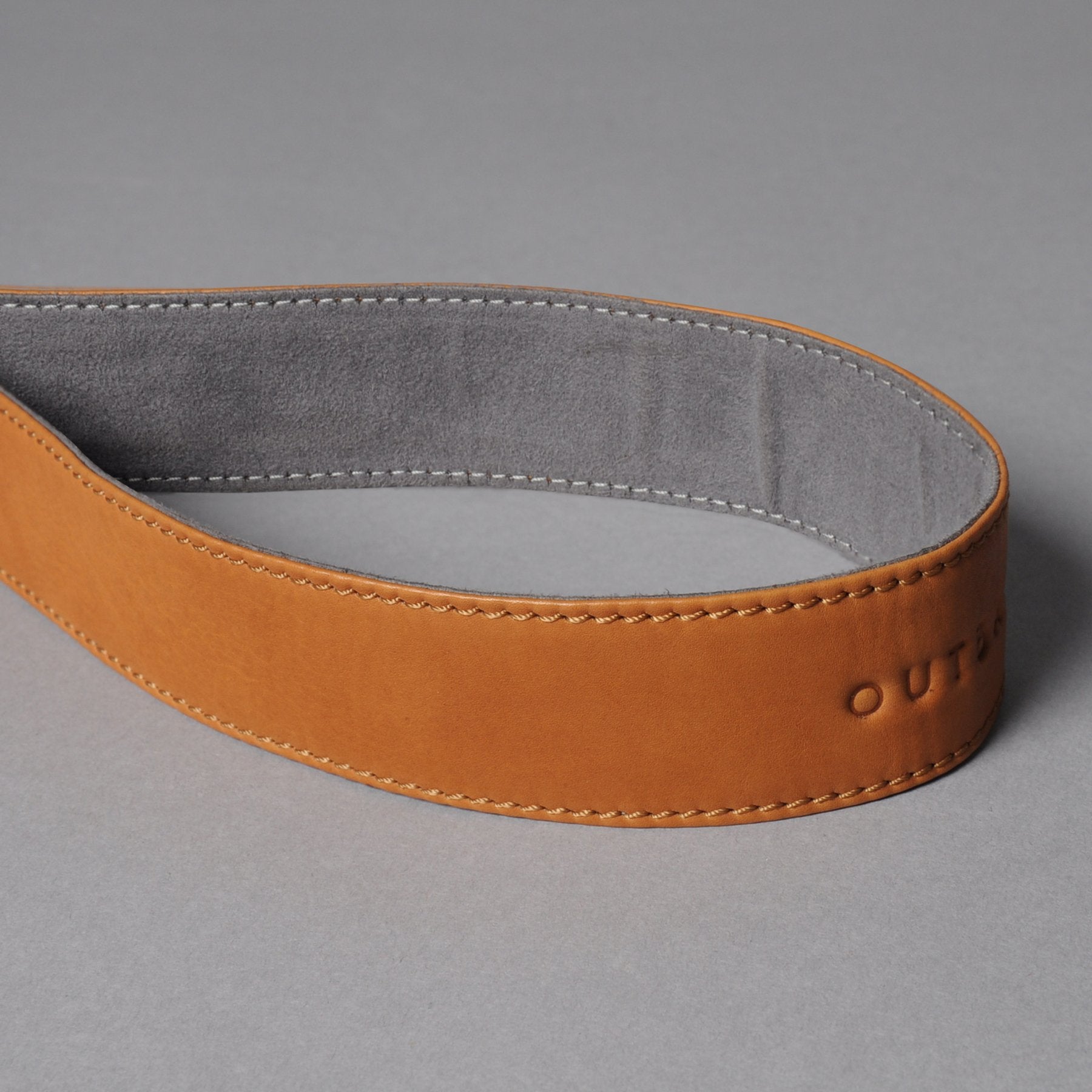 A stylish DSLR camera leather strap made from durable harness leather, featuring adjustable length and antique brass hardware.